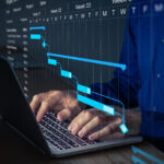 Project manager working on Gantt chart to update the schedule, tasks and milestones progress for the team. Management diagram on computer screen with person coordinating teamwork.